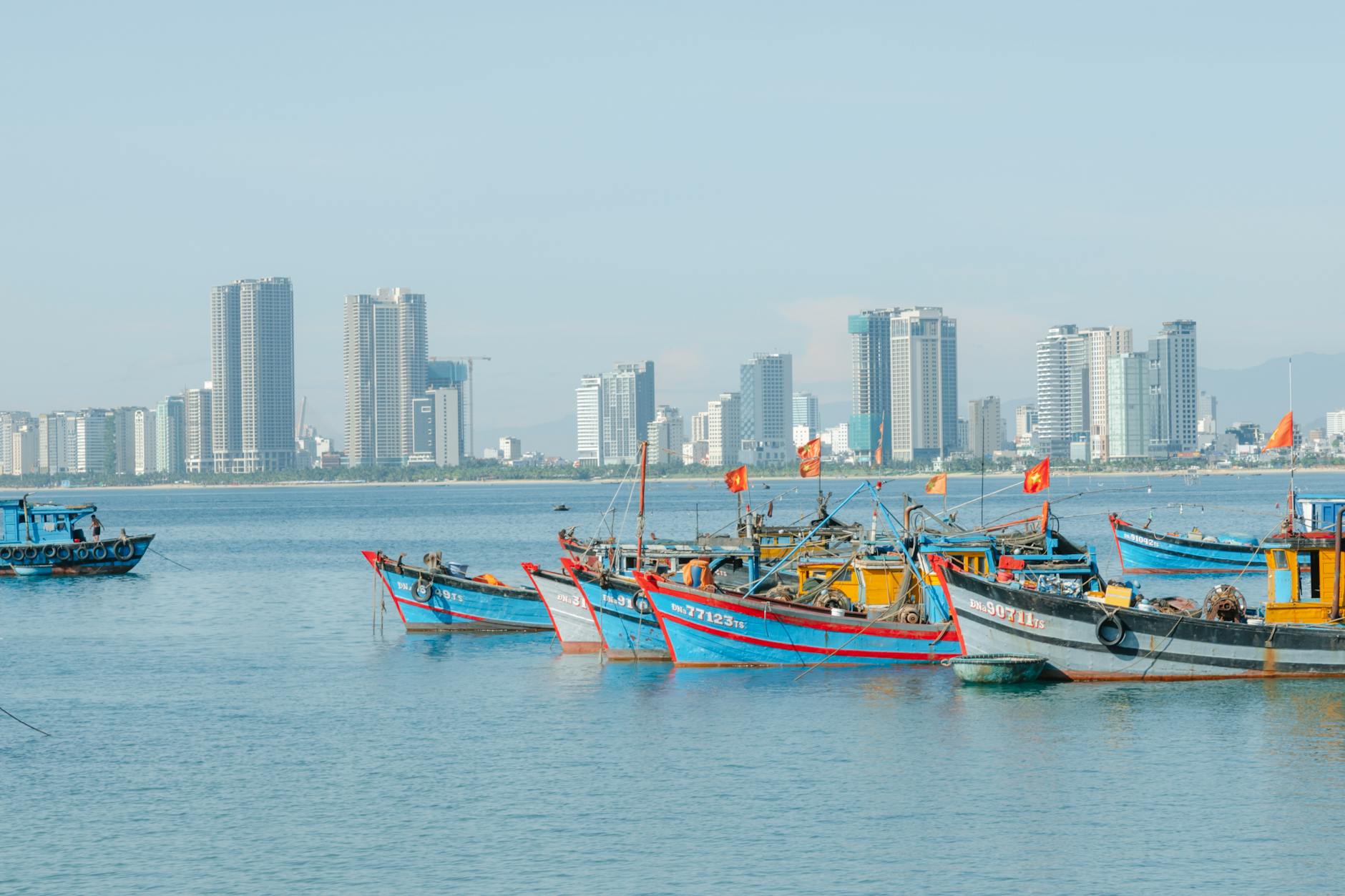 boats sailing on the sea near the city buildings