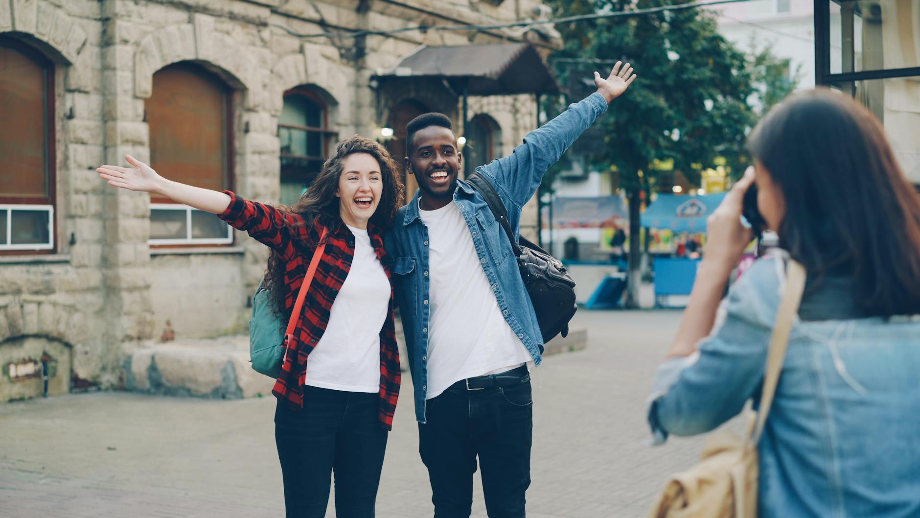 happy tourists posing for a street photo