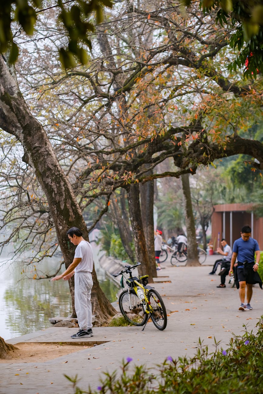 people on the promenade by the river in the park