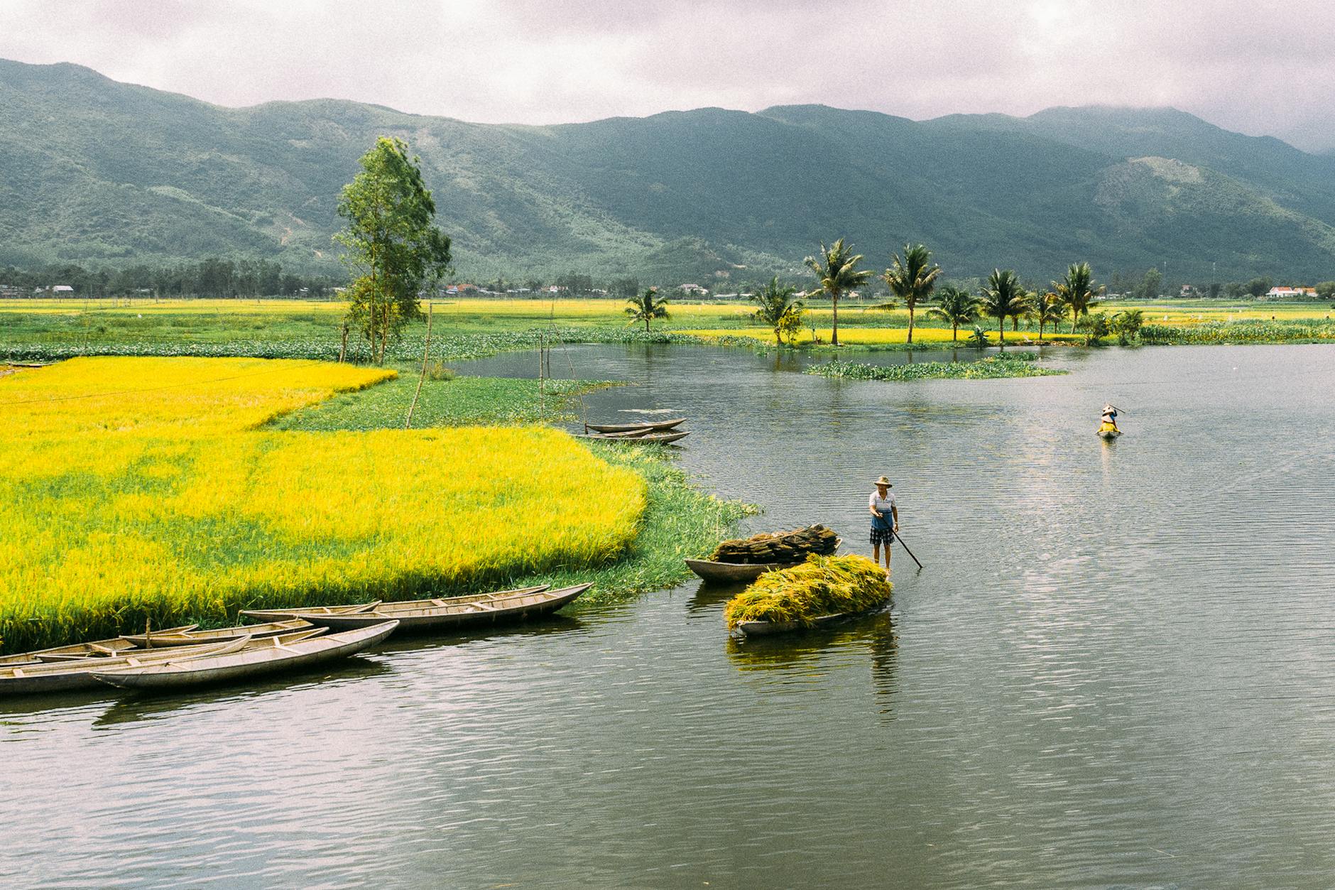 serene river landscape with farmers and boats