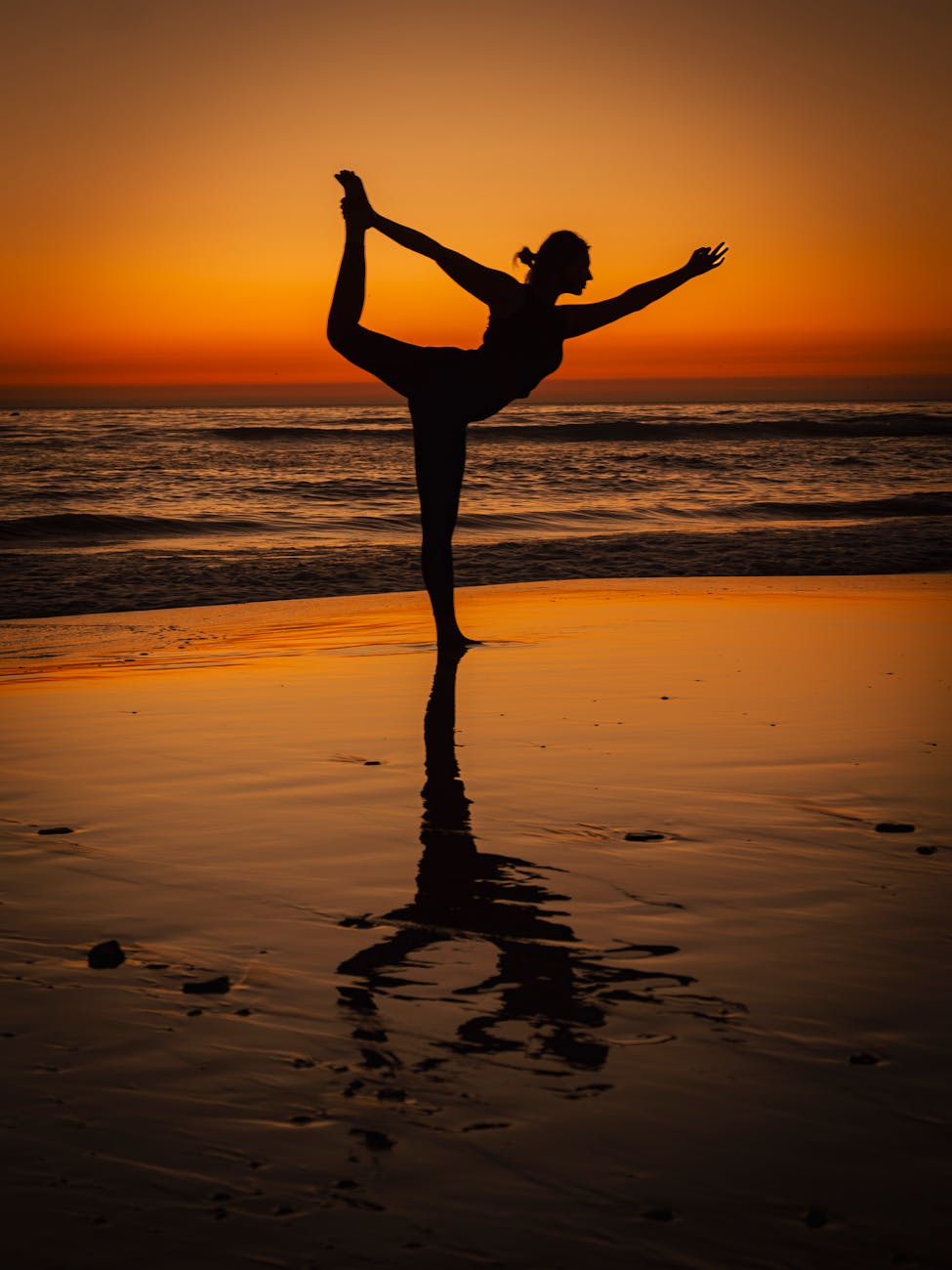 silhouette of yoga pose at sunset on moroccan beach