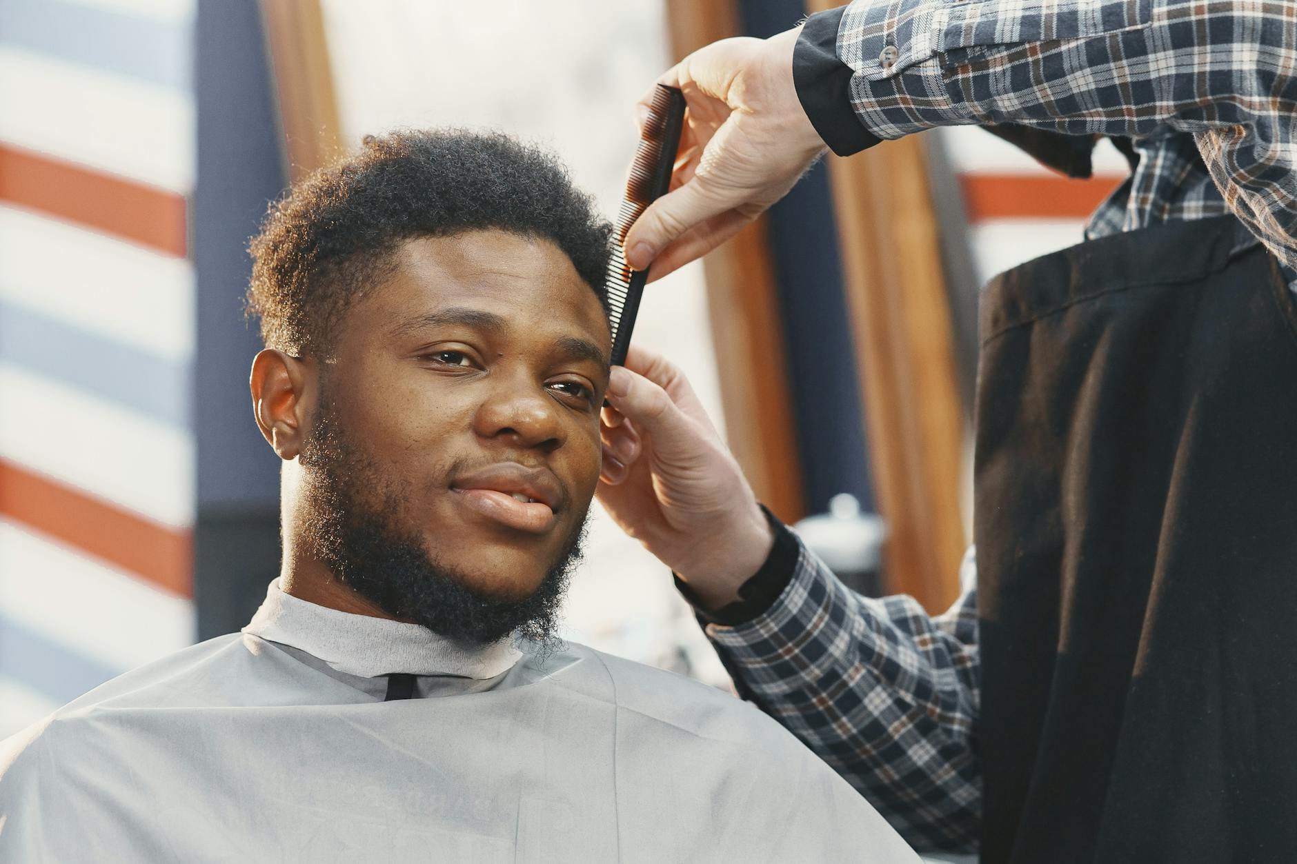 a bearded man having his haircut