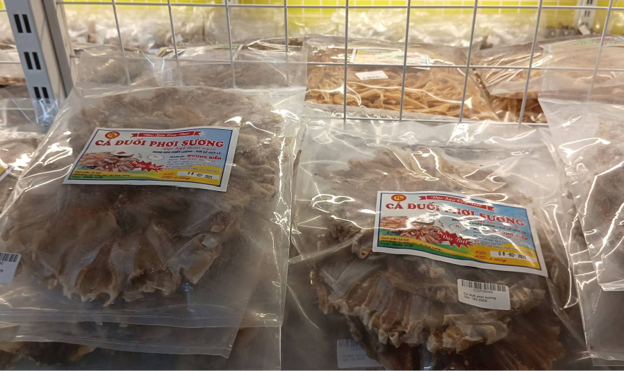 Packages of dried fish labeled with Vietnamese text, displayed on shelves.